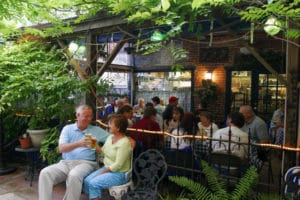 A couple clinks their beers together outside at The Bier Garden German Restaurant in Portsmouth, Virginia