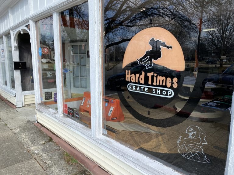 Exterior window featuring the Hard Times Skate Shop logo.