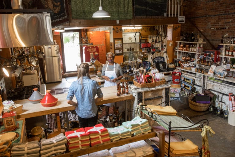 Two people talk at the counter inside The Kitchen Koop in Portsmouth, Virginia.