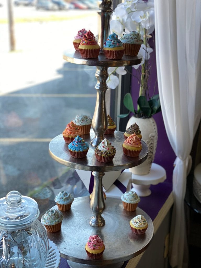 A tiered window display of cupcakes at SilverSpoon Bakery and Gourmet Gifts