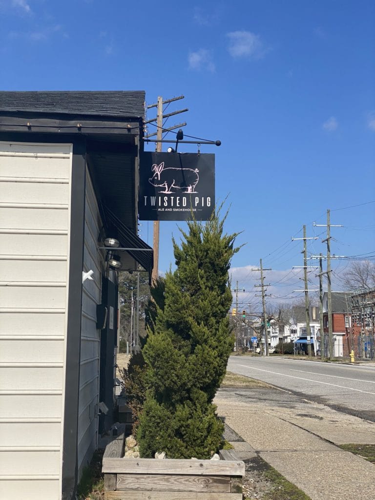 View of the restaurant sign and street across from the Twisted Pig Ale and Smokehouse in Portsmouth, Virginia