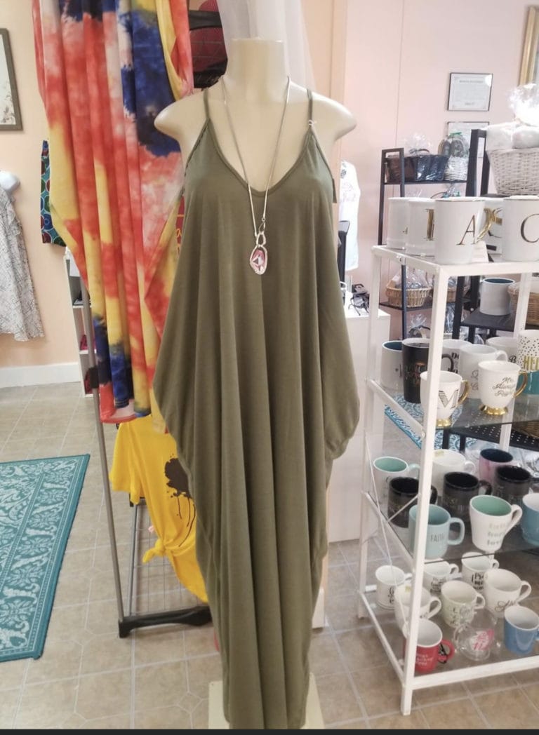 Green dress and necklace on a mannequin inside 2 Natural Gurlz Boutique in Portsmouth, Virginia