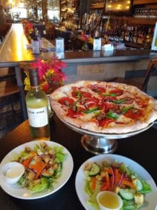 Amici's Pizza special with salad and wine