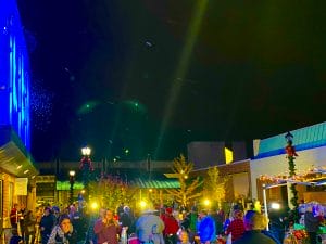 Shows manufactured snow blowing in the mall