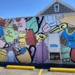 Mural featuring beans, mugs, pots, tea bags, and tools