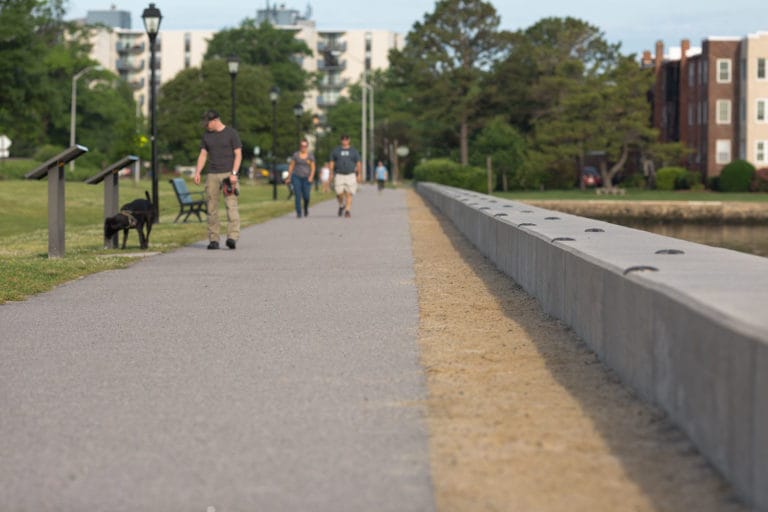 People enjoying the walking path at The Portsmouth Seawall in Portsmouth, Virginia