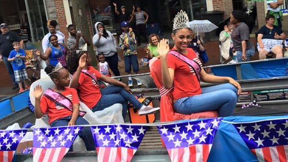 Parade participates waving at viewers