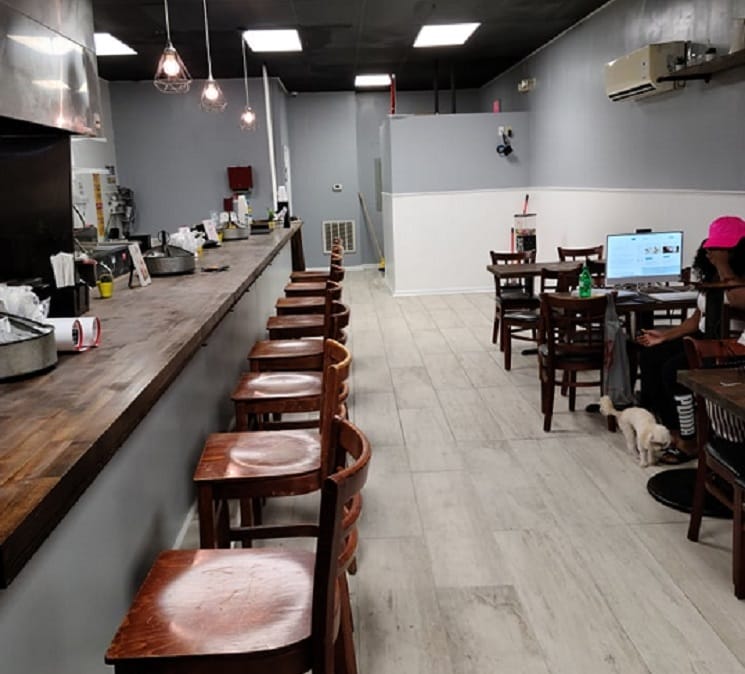 Wooden stools line the bar inside Two Up Two Down in Portsmouth, Virginia