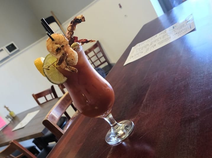 A Bloody Mary loaded with shrimp, bacon, and olives at Two Up Two Down in Portsmouth, Virginia