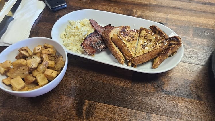 A platter of french toast, bacon, eggs, and potatoes at Two Up Two Down in Portsmouth, Virginia