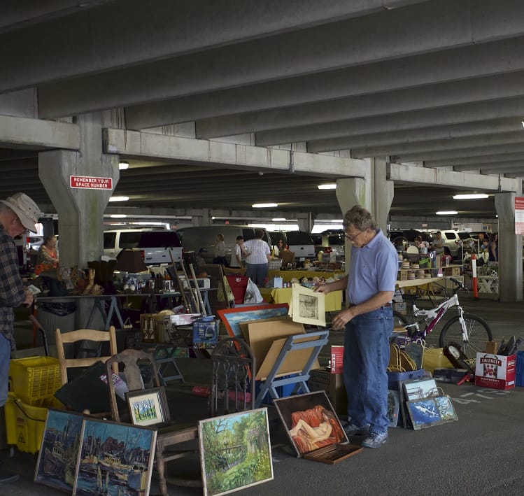 A man browses paintings for sale at the Olde Towne Antiques and Flea Market in Portsmouth, Virginia