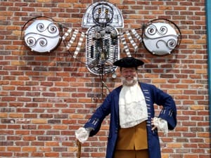 Re-enactor posed in front of Serios Steampunk Wings installation
