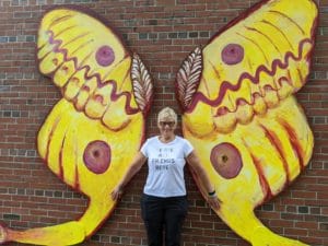 Woman posing in front of the Madagascan Moon Moth Portsmouth Public Art Wings 