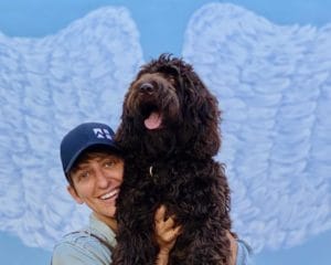 Dog and owner posing with Angelic Wings - Portsmouth Public Art