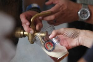 A person fills a beer from a tap at the Bier Garden in Olde Towne Portsmouth Virginia
