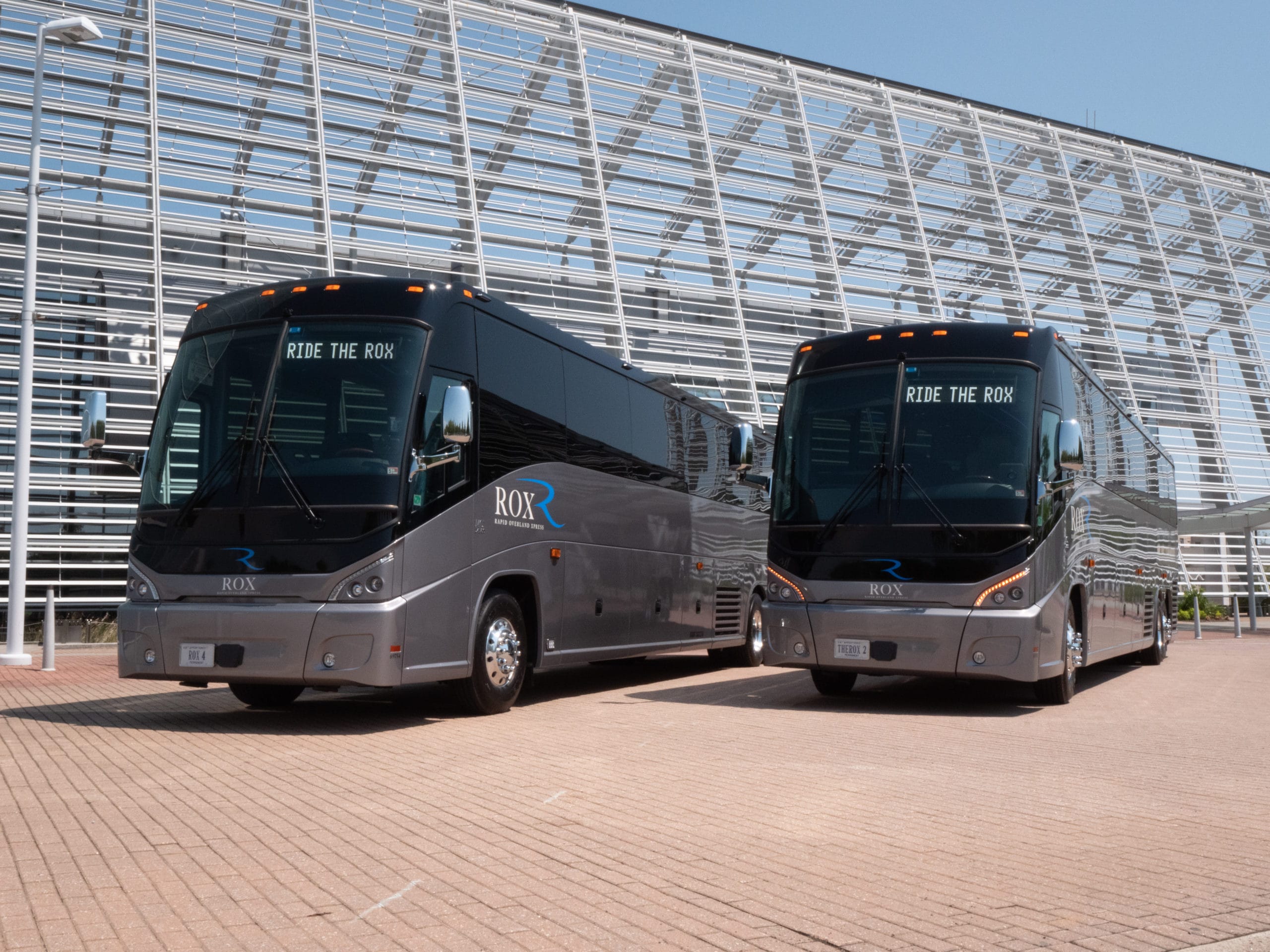 Two Rapid Overland Xpress (ROX) luxury motor coaches