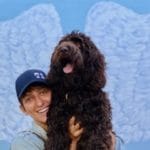 A patron holds up her dog for a picture with the Portsmouth Virginia Cultural Art Wings