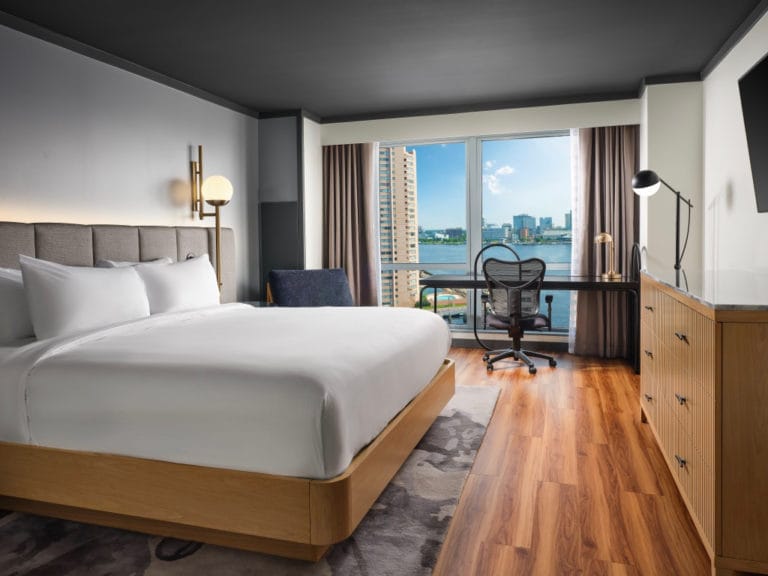 The interior of a king bed guest room overlooking the water The interior of a king bed guest room overlooking the water