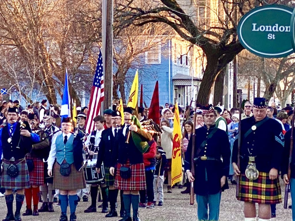 A group of men in kilts play bagpipes during Portsmouth's Olde Towne Scottish Walk