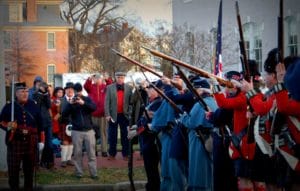 Reenactors fire guns into the air