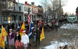 People march with Scottish flags during Portsmouth's Olde Towne Scottish Walk