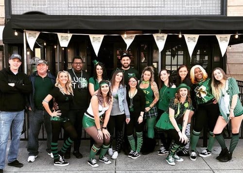 Staff poses outside of the Olde Town Public House in Portsmouth, Virginia