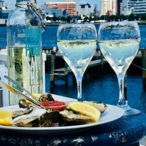 Oysters and wine with a view of the Elizabeth River at Fish & Slips Marina Raw Bar and Grill in Portsmouth, Virginia