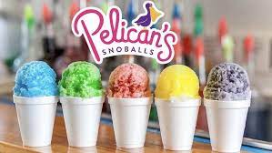 A row of cups filled with colorful shaved ice at Pelican's SnoBalls