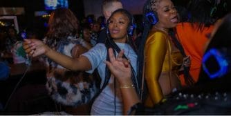 image of two women wearing headphone at a silent party 