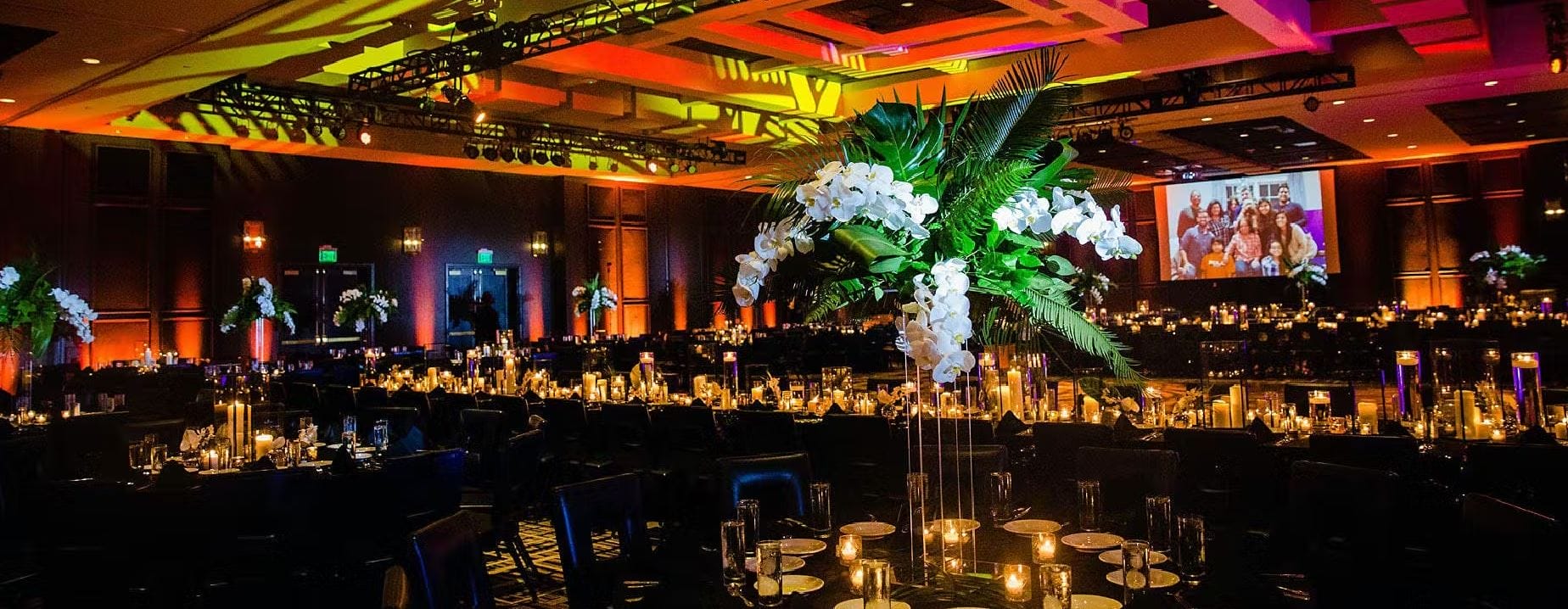 Candles and floral centerpieces line tables inside the Rivers Casino Portsmouth event space.