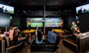 A group of people playing virtual games at TopGolf at Rivers Casino in Portsmouth, Virginia.