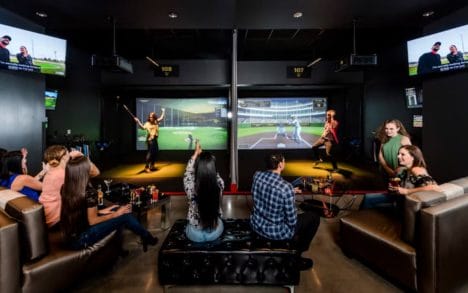 A group of people playing virtual games at TopGolf at Rivers Casino in Portsmouth, Virginia.