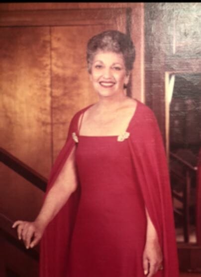 Portrait of a women- Zelma Rivin wearing a red dress. Zelma owned Famous Clothing store in Portsmouth, VA.