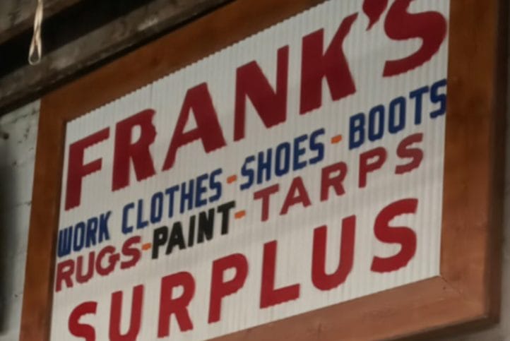 Olde Red and White sign saying Frank's Surplus.