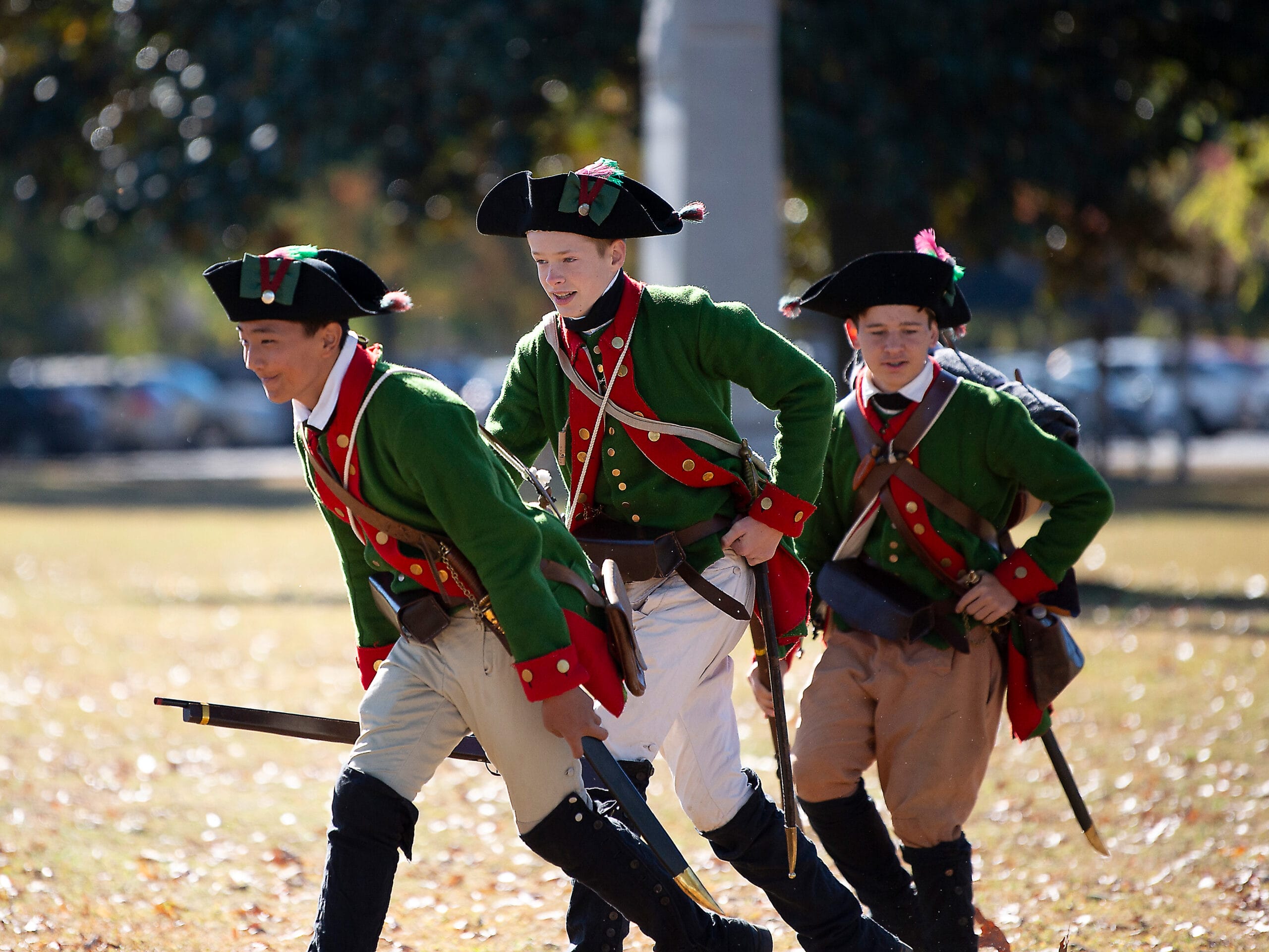 3 teenagers re-enacting Revolutionary War soldiers